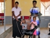 A family passing on a young goat